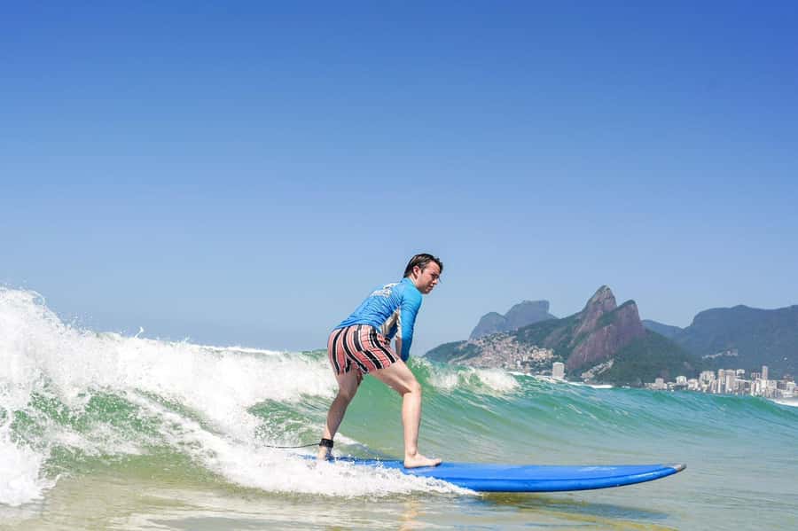 Surf lessons with local instructors in Copacabana/ipanema! - Catching a wave, then getting back out